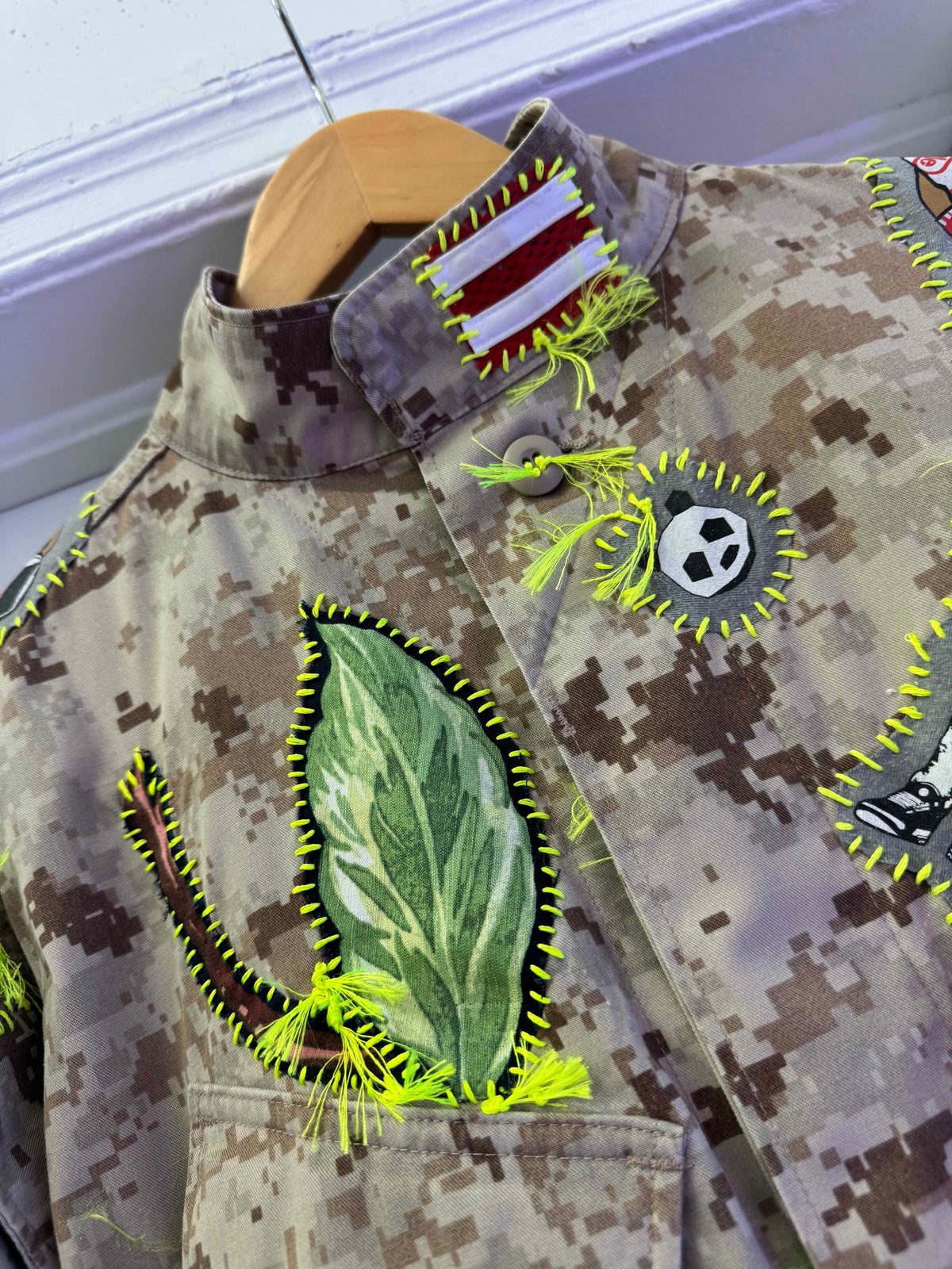 Snobiety Jacket
One-of-a-kind reclaimed camo jacket, hand-embroidered with vintage floral embroidery 
