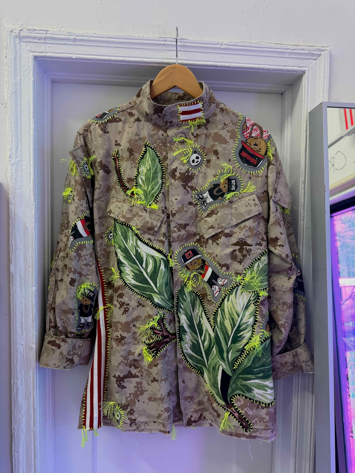 Snobiety Jacket
One-of-a-kind reclaimed camo jacket, hand-embroidered with vintage floral embroidery 