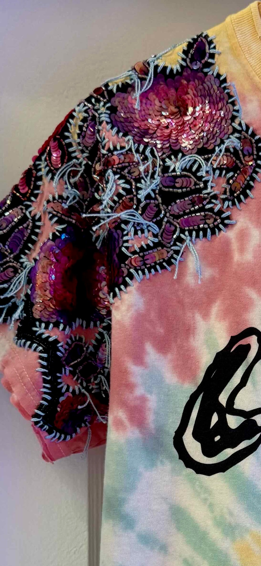 One-of-a-kind upcycled tie-dye Snoopy t-shirt with hand-embroidered sequin flowers by Gontovnik